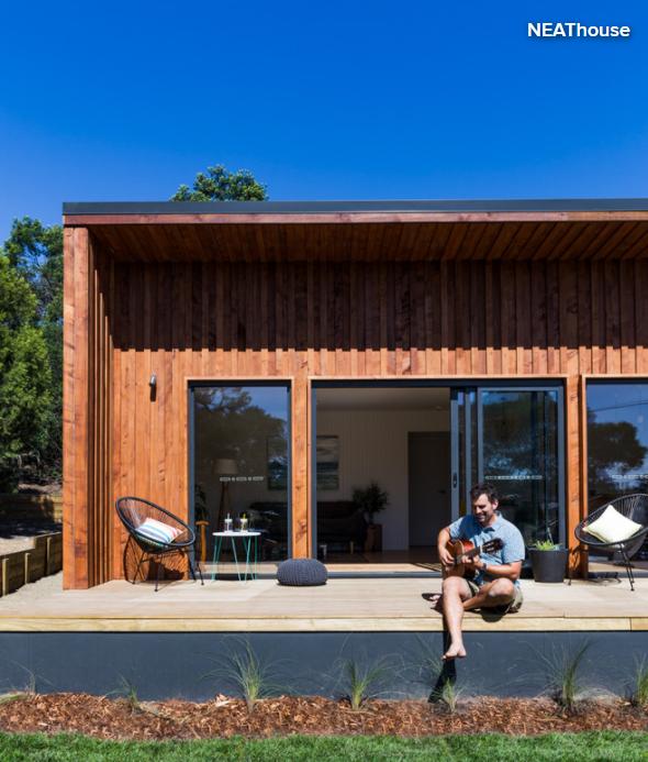 man playing guitar on veranda 