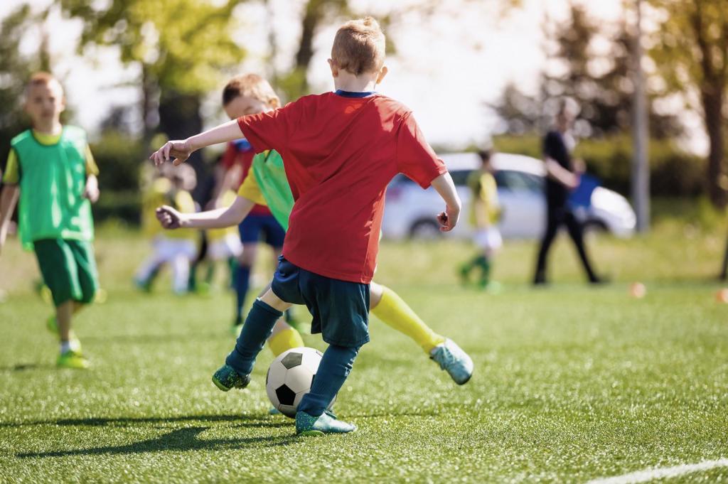 children playing soccer outside 