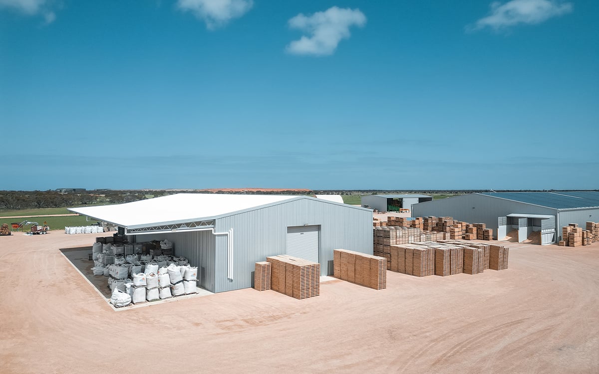 Exterior of Morgan Sawmill’s industrial steel structures and timber storage yard, featuring galvanised framing and efficient site layout.