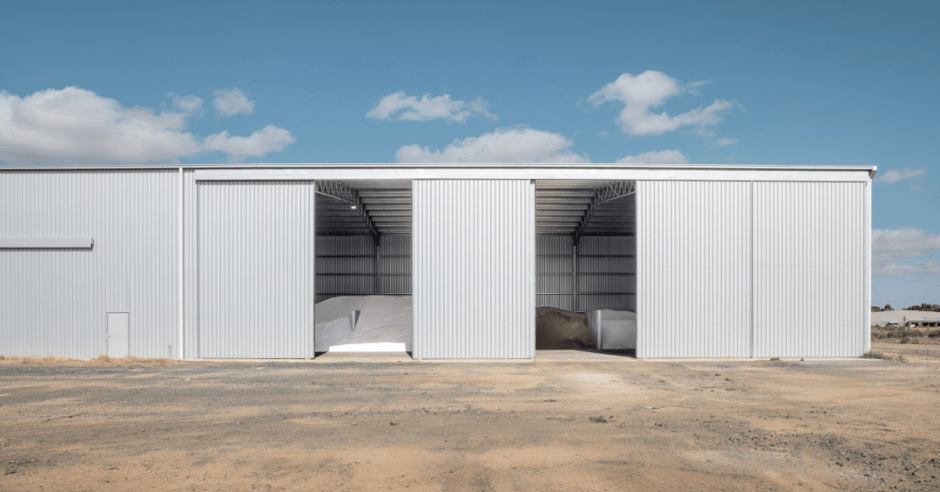 A fertiliser storage shed seen from side, with doors open.